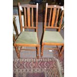 A pair of early 20th Century oak single dining chairs,