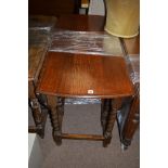 A 20th Century oak drop leaf dining table, raised on barley twist gatelegs, 150cms long.