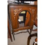 A stained wood radio cabinet (now empty) with a pair of sliding doors,