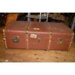 A brass mounted wooden bound travelling trunk, with Kingscross Railway label.