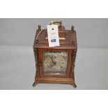 A modern bracket type clock by Warmink, with moon phase dial, in stained oak case with brass mounts.