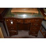 A reproduction mahogany kneehole desk,