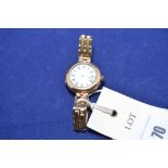 A 15ct gold ladies wrist watch, with white enamel roman dial, 29grms gross.