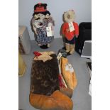 A pair of Eskimo Inuit fur boots; moccasins; a carving; and two dolls on stands.