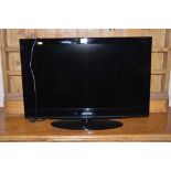 A Samsung flat screen television. model no.LE32D400E1W, with remote control.