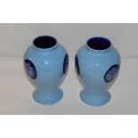 A pair of Moorcroft blue florian ware vases, dated 2013, signed with initials "L.E.".