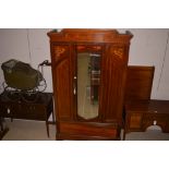 An Edwardian inlaid walnut bedroom suite, comprising: wardrobe bevelled mirror door,