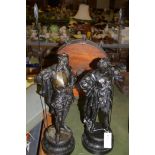 A pair of spelter figures, in armour holding spears, on socle bases.