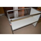 A modern metal and glass display cabinet, 124cms wide.
