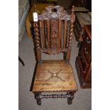 A Victorian carved oak hall chair, barley twist supports.