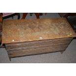 A 20th Century oak blanket box, with carved decoration to front raised on feet, 91.5cms wide.