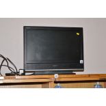 A Sony flat screen television model no. KDL20S3000 with remote control.