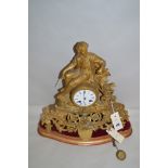 A 19th Century mantel clock, by Reid & Sons, figure of a farm boy to top, raised on scrolling base,