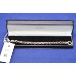 A 9ct yellow gold U-shaped link bracelet, in black leather effect case, 24grms.