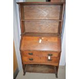 A late 19th Century bureau bookcase the fall flap opening to reveal pigeon holes and drawers,