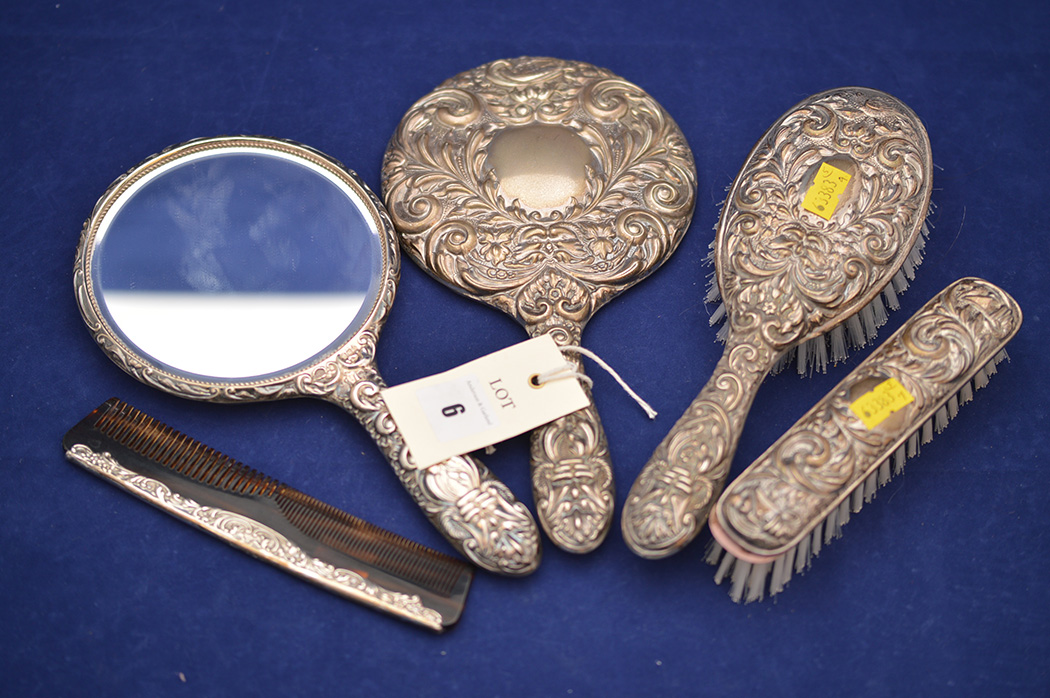 An Elizabeth II silver dressing table set by W.I. Broadway & Co.