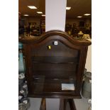 A 20th Century stained oak glazed display cabinet.