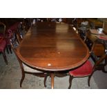 A reproduction inlaid mahogany extending dining table, one spare leaf, 196cms long.