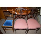 A pair of Victorian mahogany balloon chairs with carved and pierced splats, raised on cabriole legs,