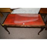 A 20th Century stained wood rectangular coffee table, inset red leather, glass top, 20cms wide.