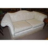 A 19th Century style two-seater settee upholstered in cream floral patterned material,