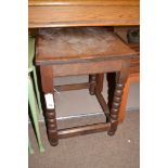 A 20th Century oak rectangular occasional table, raised on bobbin turned legs joined by stretchers.