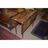 A Georgian oak drop leaf dining table,