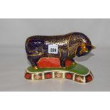 A Royal Crown Derby paperweight in the form of a bull, with gold coloured stopper.