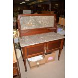 A Victorian mahogany wash stand with marble top and back, cupboard doors below, 107cms wide.