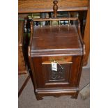 A Victorian mahogany coal box with brass fittings, carved panel with brass scoop.