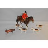 A Beswick huntsman on horseback, together with four hounds and a fox (some damages). (6).