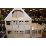 A large unpainted dolls house.