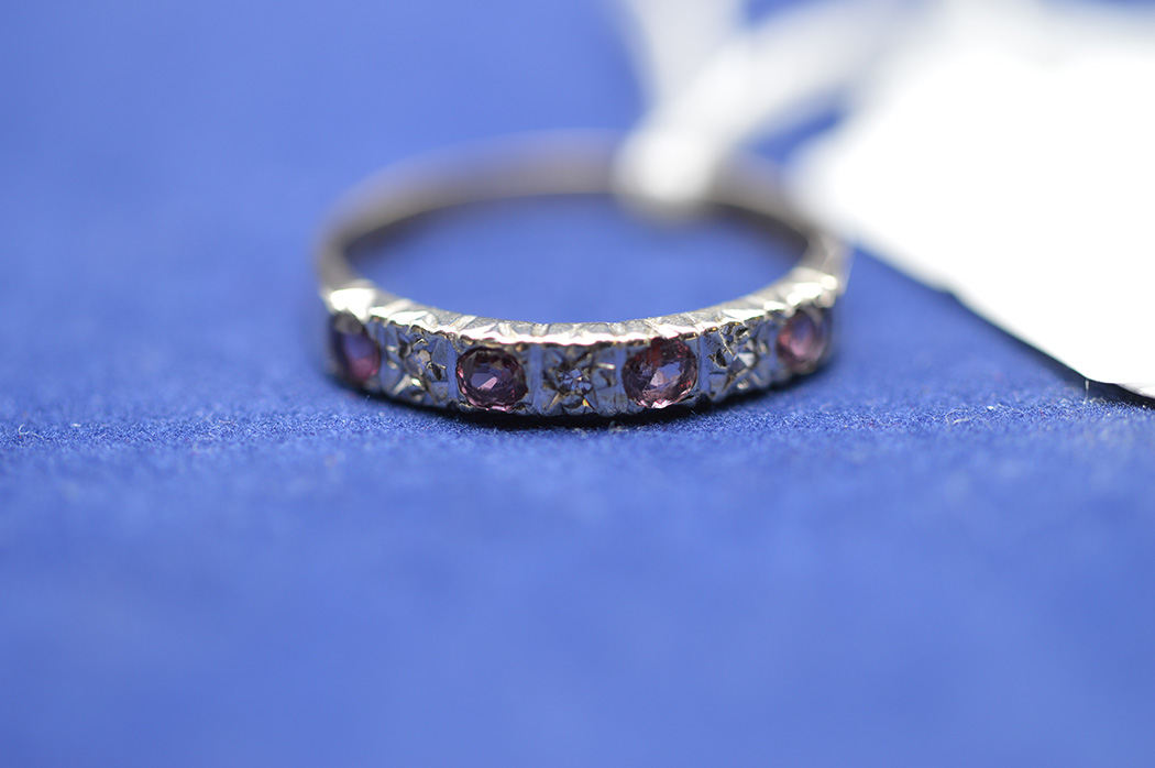 A 9ct yellow gold ring set rubies and illusion mounted diamonds, ring size O, 1.8grms gross.