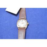 A 9ct yellow gold wristwatch by Reid, on brown leather strap, in original case, 21.5grms gross.