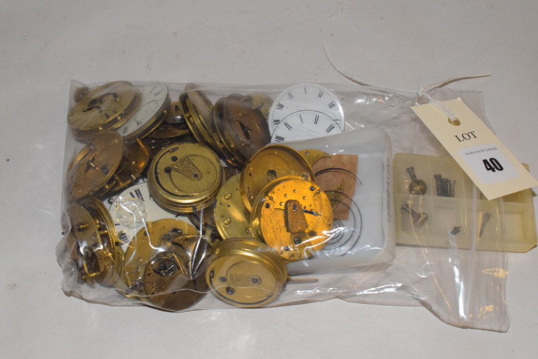 Pocket watch movements and assorted parts.