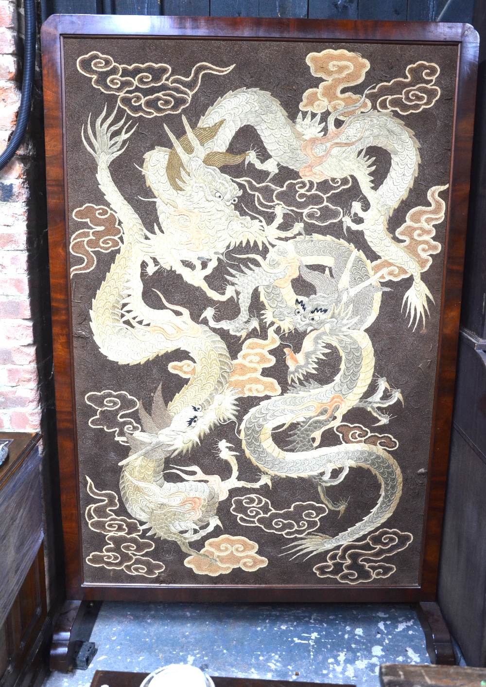 A large Asian textile, wood mounted as a