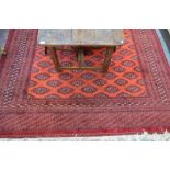 A Turkoman carpet red/brown ground with