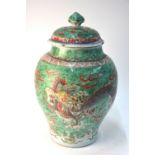 A Chinese wucai oviform vase with unglazed base; the associated domed cover with knop finial;