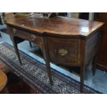 A George III satinwood crossbanded mahogany sideboard of breakfront form, the centre frieze drawer