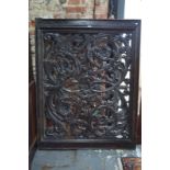 An antique oak panel, carved and pierced with floral and foliate scrollage, in moulded frame, 141