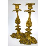 A pair of 19th century French Rococo Revival ormolu candlesticks, signed beneath AN, 25 cm high