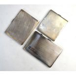 Three various engine-turned silver cigarette cases, 16 oz
