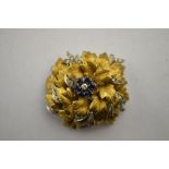 An 18th yellow and white gold stylised flower brooch having sapphire and diamond cluster centre,