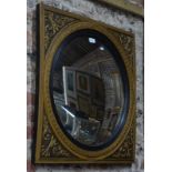 A convex mirror in square gilt plaster decorative frame, 71 cm