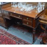 An early Victorian mahogany desk with three-quarter gallery top above five drawers, on baluster