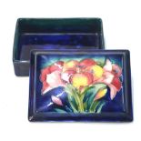 A Moorcroft rectangular trinket box and cover, blue ground decorated with the 'Freesia' pattern,