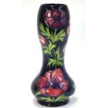 A Moorcroft contemporary vase of waisted form decorated with the 'Anemone' pattern on a blue ground,