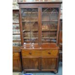 An early 19th century mahogany secretaire bookcase with twin astragal-glazed doors above fall
