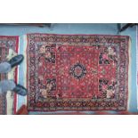 A fine Persian Bidjar rug, the blue central medallion on red ground within floral borders,