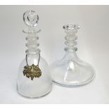 Two plain decanters, each with three neck rings, one bell shaped with target stopper and a silver